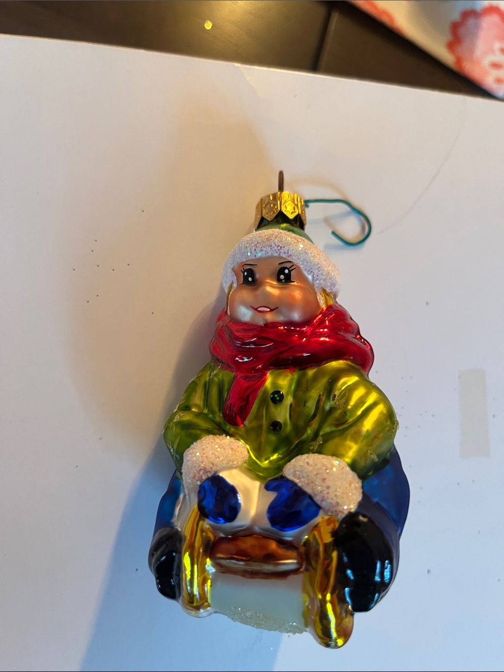 Christopher Radko Glass Sledder Ornament - Green Coat, Red Scarf, Blue Mittens